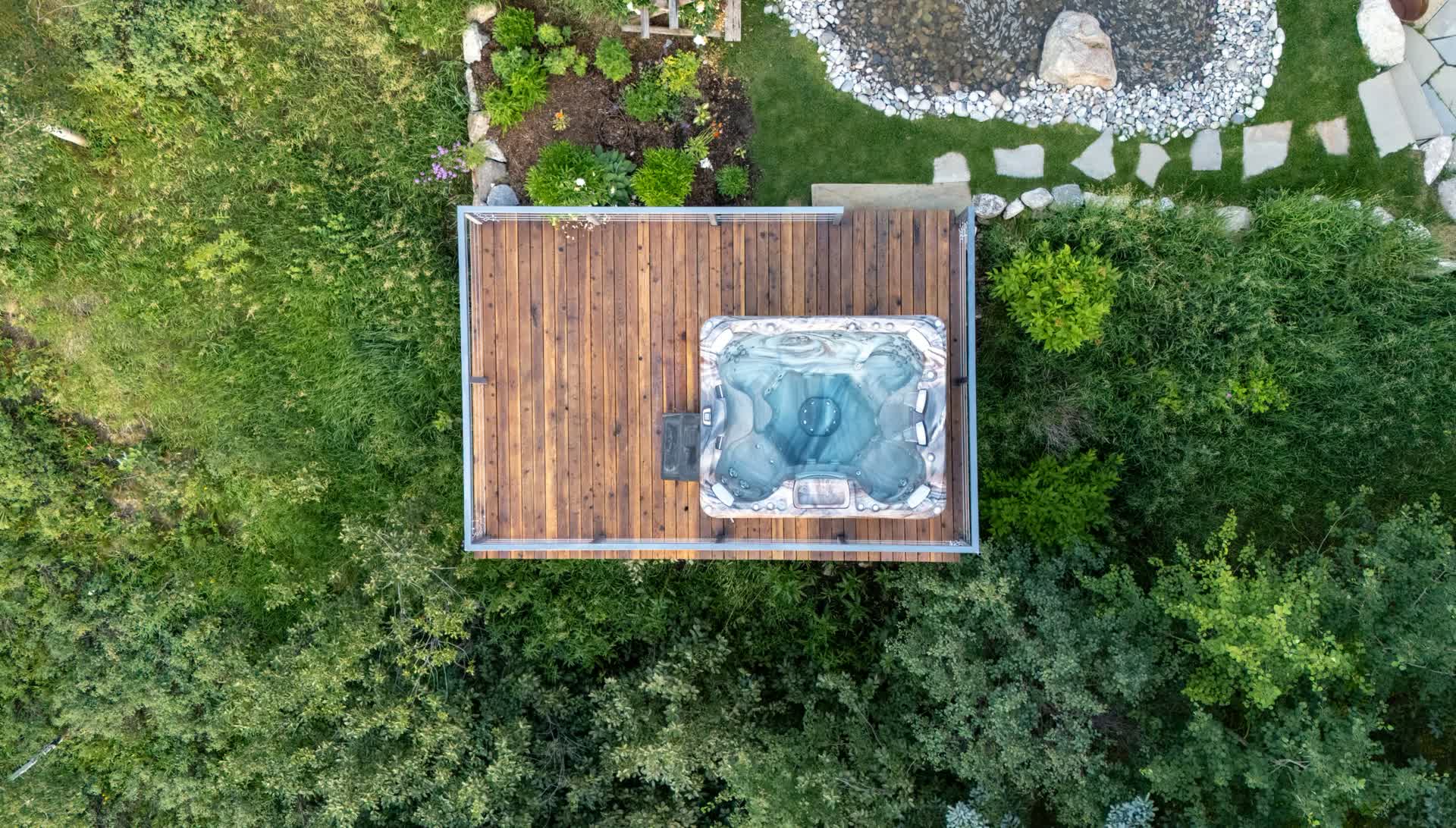 Sundance hot tub on a cedar deck, seen from above